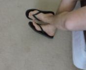 Showing off bare feet and flip flops, wiggling toes and flexing feet