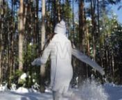 Get 100&#39;s of FREE Video Templates, Music, Footage and More at Motion Array: http://bit.ly/2SITwWM nnnGet this here: https://motionarray.com/stock-video/girl-skips-in-snow-156137nnThis video clip showcases a young woman skipping through a snowy forest. She hops through the ankle-deep snow. The is wearing a long white sweater over gray pants. A long white knit scarf and matching hat and mittens keep her cozy in the cold crisp air. Snow sprays up each time she pulls her foot from the snow to make a