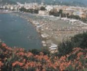 Archival footage shot in the summer of 1971 by Carlo Casu, an Italian filmmaker who gave the rights to distribute his historical footage.nnIt contains stock footage of Sestri Levante, a coastal town in the Italian Riviera: panoramas of the beach with people swimming and relaxing, boats docking in the port, the Torre Marconi (Marconi Tower), and more.nnPlease, comment if you recognize more subjects. nnIf you want to watch this video without the watermark and advertising, please visit: nhttps://my