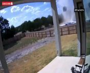 A dog remained calm on the porch of its home in San Antonio in the US, watching as a dust devil swirled through the backyard, sending objects flying into the air.