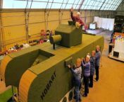 A community group has knitted a life-sized tank to commemorate the 80th anniversary of the D-Day landings.&#60;br/&#62;&#60;br/&#62;Around 30 volunteers spent eight hours a day for nine months knitting eight-inch squares for the artwork, which was modelled on a Churchill AVRE tank. The stunning creation is now a whopping 24ft (7.3cm) wide and 7ft (2.1m) tall and is covered in the olive green squares that the volunteers knitted.