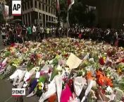 Tearful Australians lay flowers Tuesday at the popular Sydney cafe where a gunman held hostages for 16 hours.